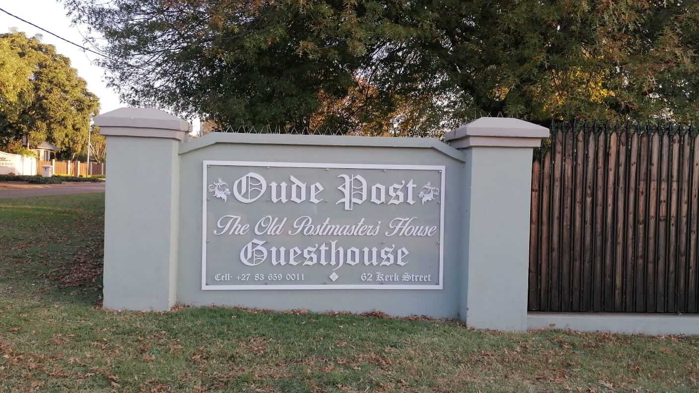 Oude Post Guesthouse street signage with contact details